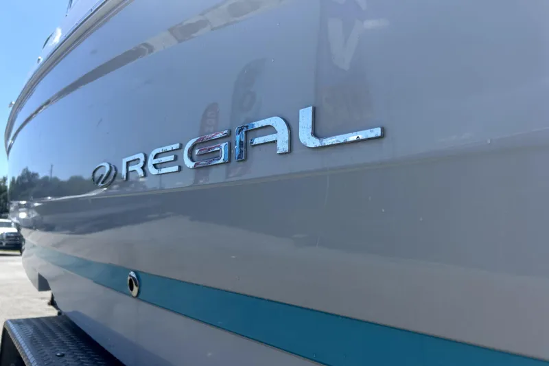 Slide: The Image of 2021 Regal 26 FasDeck boat side view with logo in sunlight. - 65