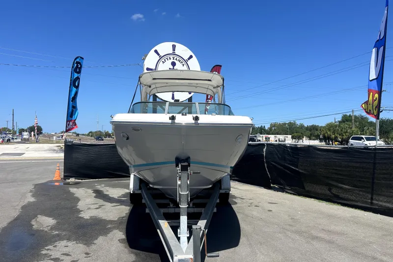 Slide: The Image of 2021 Regal 26 FasDeck boat on trailer at dealership under clear blue sky. - 7