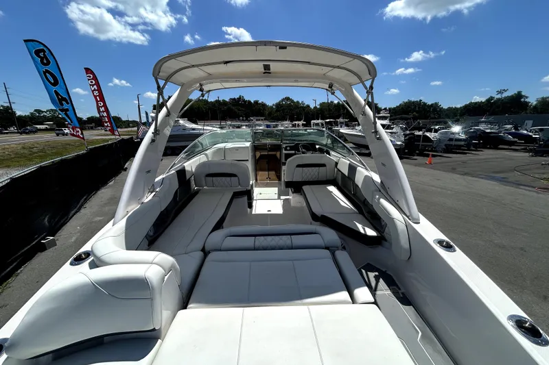 Slide: The Image of 2021 Regal 26 FasDeck boat with spacious seating, docked under a clear blue sky. - 71