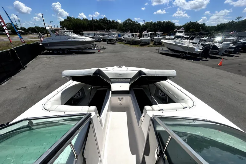 Slide: The Image of 2021 Regal 26 FasDeck boat in a marina, surrounded by other boats under a sunny sky. - 75