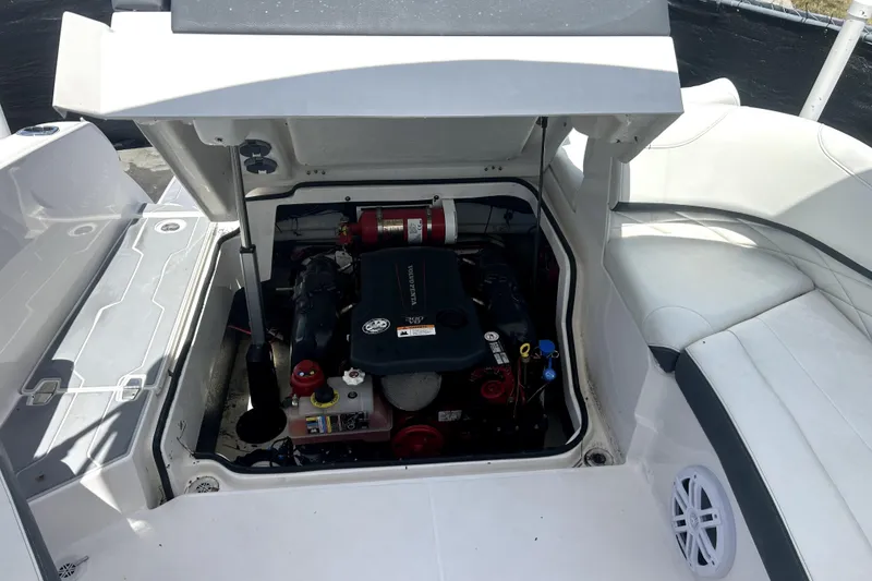 Slide: The Image of 2021 Regal 26 FasDeck boat engine compartment with open hatch, showcasing engine and components. - 79