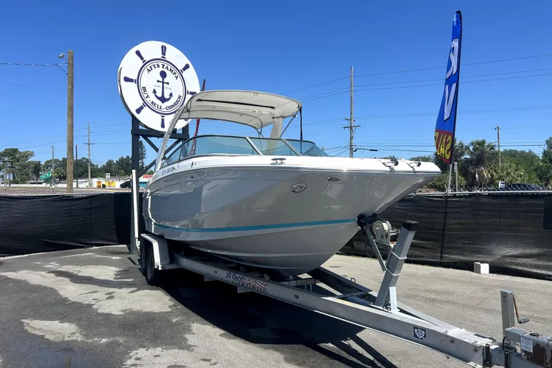 Slide: The Image of 2021 Regal 26 FasDeck boat on trailer at dealership under clear blue sky. - 8