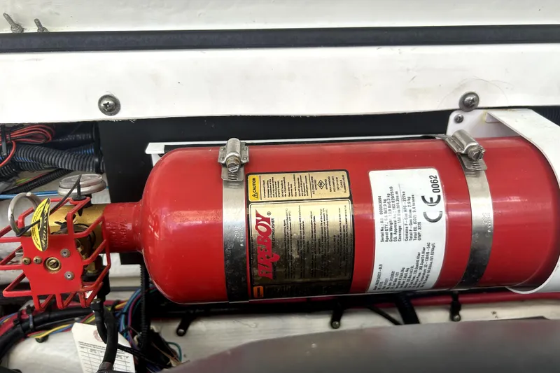 Slide: The Image of Red fire extinguisher in a 2021 Regal 26 FasDeck boat engine compartment. - 80