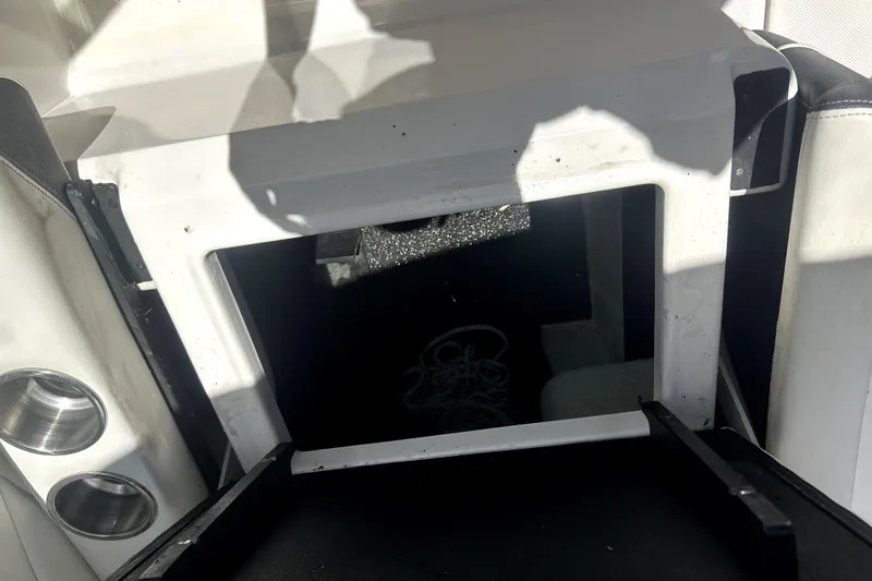 Slide: The Image of Interior storage compartment of 2021 Regal 26 FasDeck boat, featuring cup holders. - 84