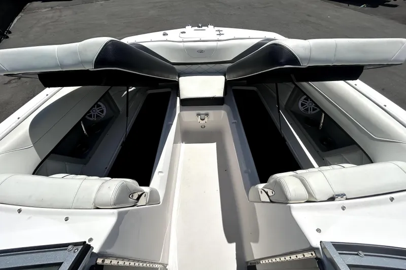 Slide: The Image of 2021 Regal 26 FasDeck boat interior with white seating and storage compartments. - 85