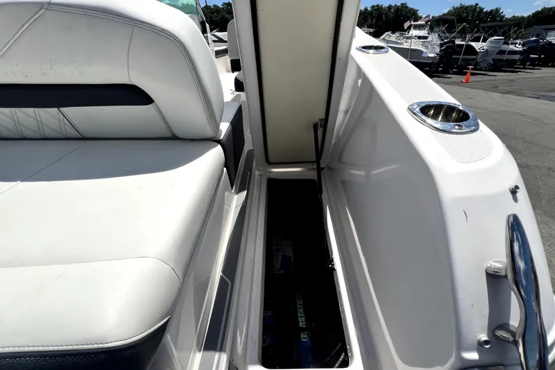 Slide: The Image of 2021 Regal 26 FasDeck boat interior with open storage compartment and seating. - 86