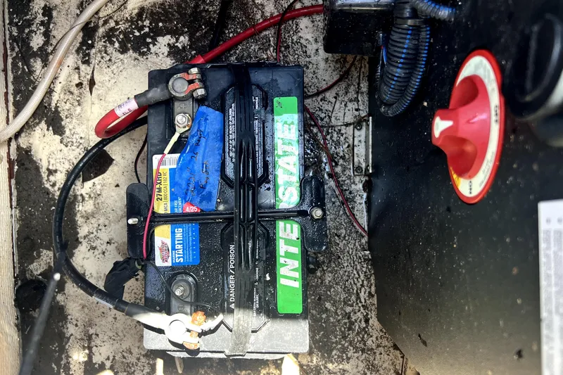 Slide: The Image of Battery compartment of a 2021 Regal 26 FasDeck boat with Interstate battery. - 88