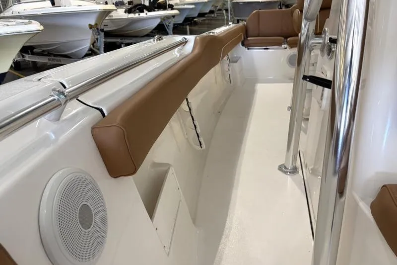 Slide: The Image of 2025 Key West 239 FS boat interior with tan seating and stainless steel railings. - 11