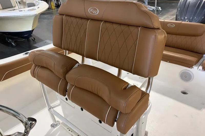 Slide: The Image of 2025 Key West 239 FS boat with tan leather seating and KW logo. - 13