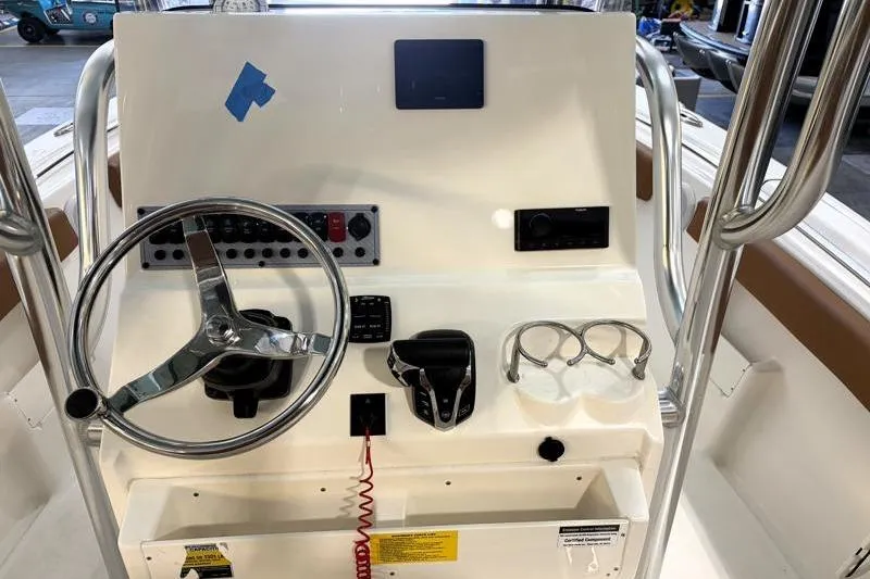 Slide: The Image of 2025 Key West 239 FS boat console with steering wheel and controls. - 15