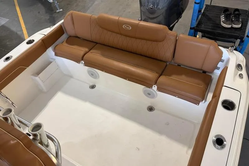 Slide: The Image of 2025 Key West 239 FS boat interior with brown leather seating and cup holders. - 17