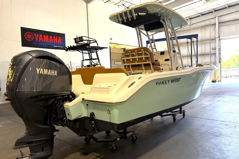 Slide: The Image of 2025 Key West 239 FS boat with Yamaha engine in a warehouse setting. - 2