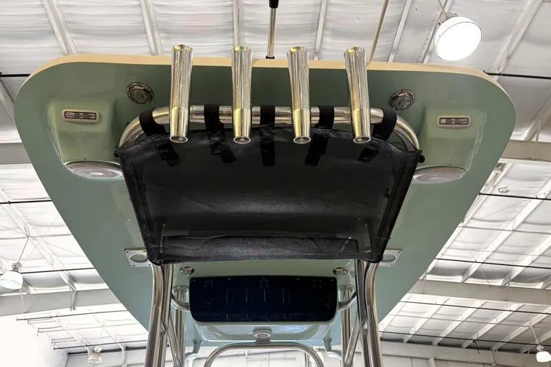 Slide: The Image of 2025 Key West 239 FS boat top view with rod holders and canopy in a showroom. - 22