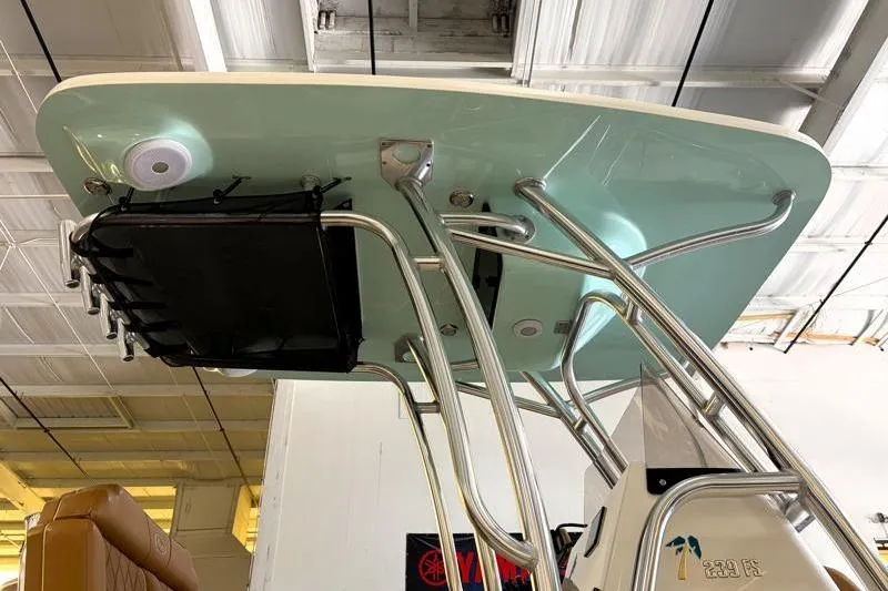 Slide: The Image of 2025 Key West 239 FS boat T-top with stainless steel frame in a showroom. - 6