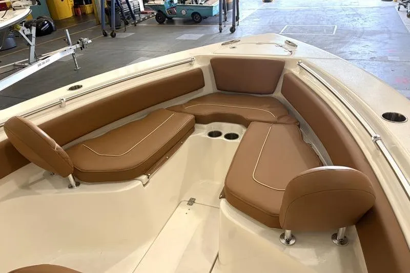 Slide: The Image of 2025 Key West 239 FS boat interior with brown cushioned seating and cup holders. - 7