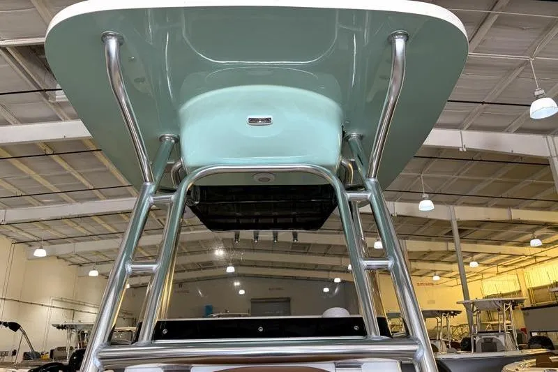 Slide: The Image of 2025 Key West 239 FS boat in a showroom, showcasing its sturdy T-top design. - 9