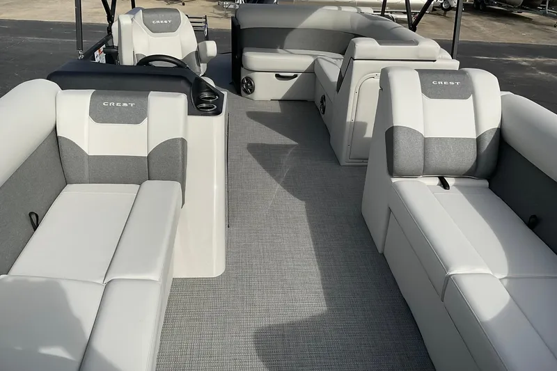 Slide: The Image of 2026 Crest Conquest SE 220 Cruise pontoon boat interior with gray and white seating. - 10