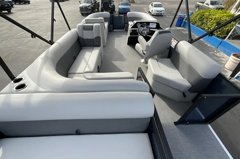 Slide: The Image of 2026 Crest Conquest SE 220 Cruise pontoon boat interior with plush seating and modern helm. - 16