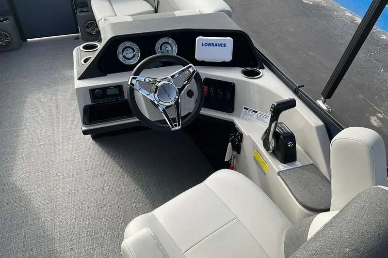 Slide: The Image of 2026 Crest Conquest SE 220 Cruise boat interior with steering wheel and control panel. - 17