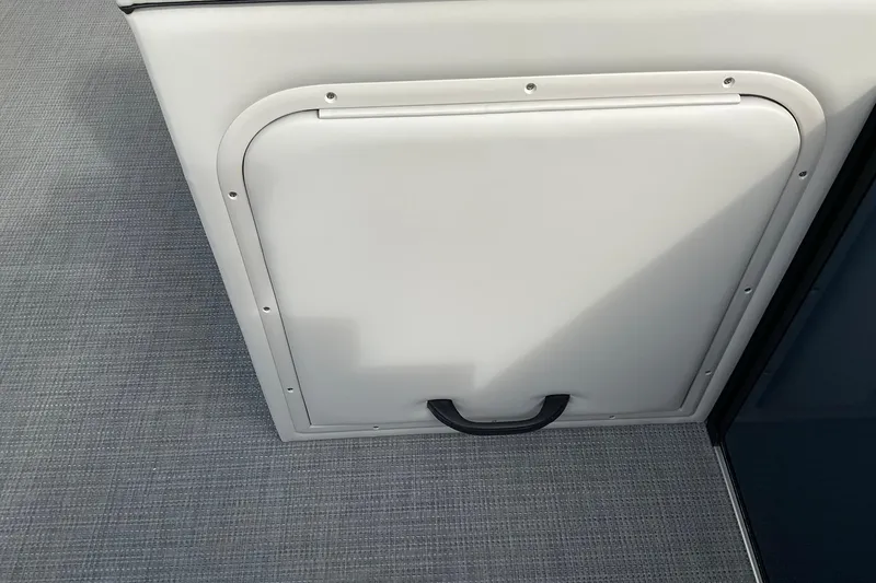 Slide: The Image of Storage compartment on 2026 Crest Conquest SE 220 Cruise boat, featuring a sleek white design. - 22