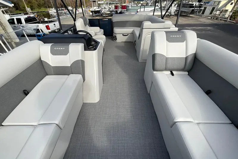 Slide: The Image of 2026 Crest Conquest SE 220 Cruise pontoon boat interior with gray and white seating. - 23