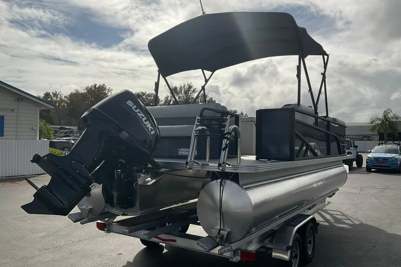 Slide: The Image of 2026 Crest Conquest SE 220 Cruise pontoon boat with Suzuki outboard motor on trailer. - 3