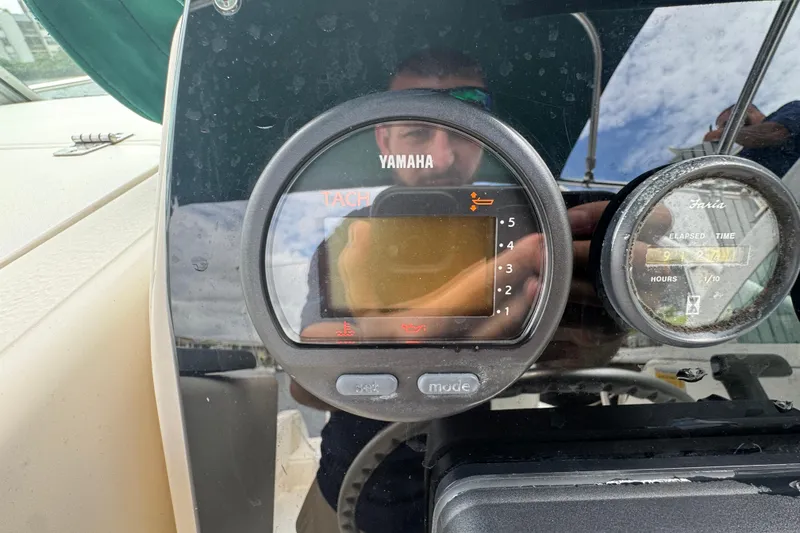 Slide: The Image of Yamaha tachometer and Faria elapsed time gauge on 2000 Pursuit 2470 Walkaround boat dashboard. - 12