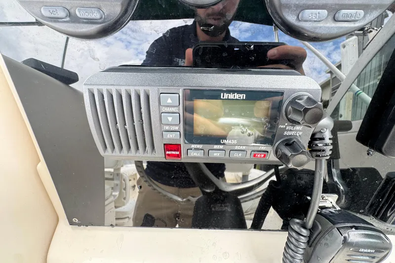 Slide: The Image of Uniden UM435 radio on a 2000 Pursuit 2470 Walkaround boat dashboard. - 17