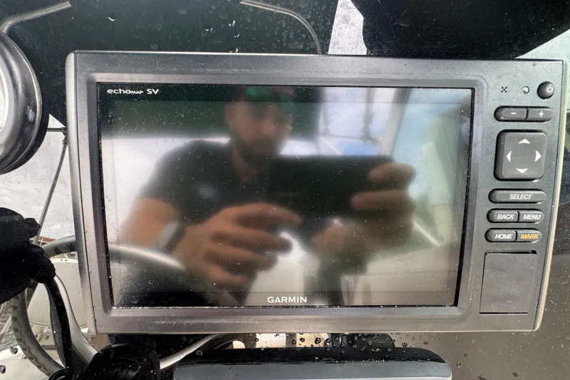 Slide: The Image of Garmin echomap SV on 2000 Pursuit 2470 Walkaround boat, reflecting a person taking a photo. - 18