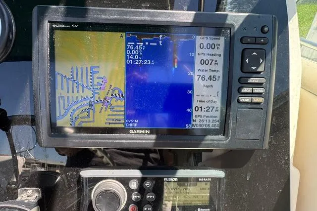 Slide: The Image of Garmin GPS display on 2000 Pursuit 2470 Walkaround boat, showing navigation and water temperature. - 19