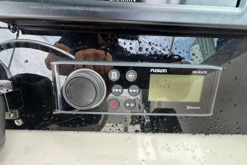 Slide: The Image of Fusion MS-RA70 marine stereo on a 2000 Pursuit 2470 Walkaround boat dashboard. - 20