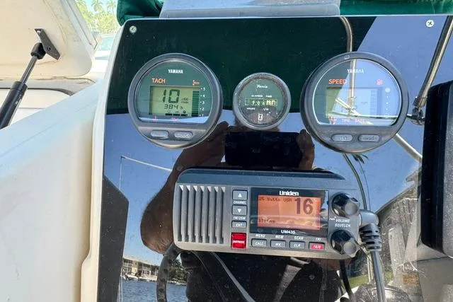 Slide: The Image of Dashboard of a 2000 Pursuit 2470 Walkaround boat with Yamaha gauges and Uniden radio. - 21