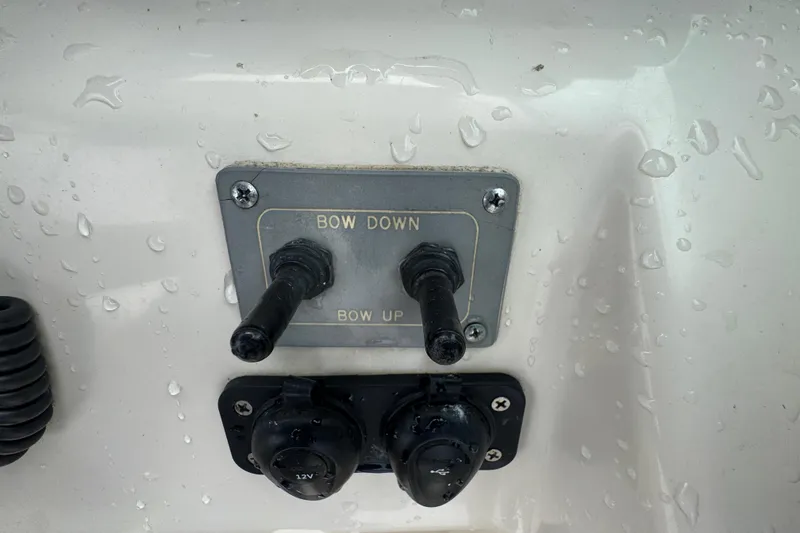 Slide: The Image of Boat control panel with "Bow Down" and "Bow Up" switches, Pursuit 2470 Walkaround, 2000 model. - 22