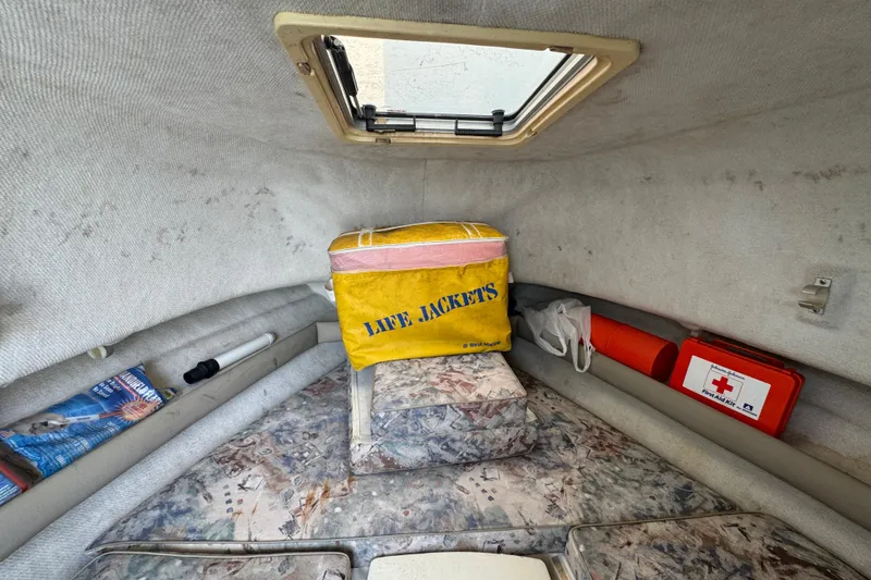 Slide: The Image of Interior cabin of a 2000 Pursuit 2470 Walkaround with life jackets and safety gear. - 26
