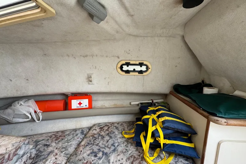 Slide: The Image of Interior of a 2000 Pursuit 2470 Walkaround boat with life jackets and first aid kit. - 27