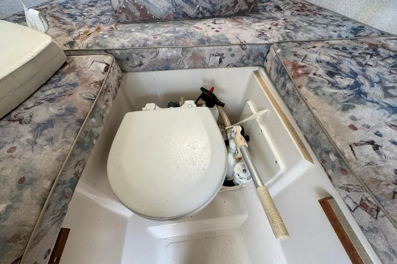 Slide: The Image of Boat interior with a toilet in a 2000 Pursuit 2470 Walkaround model. - 28