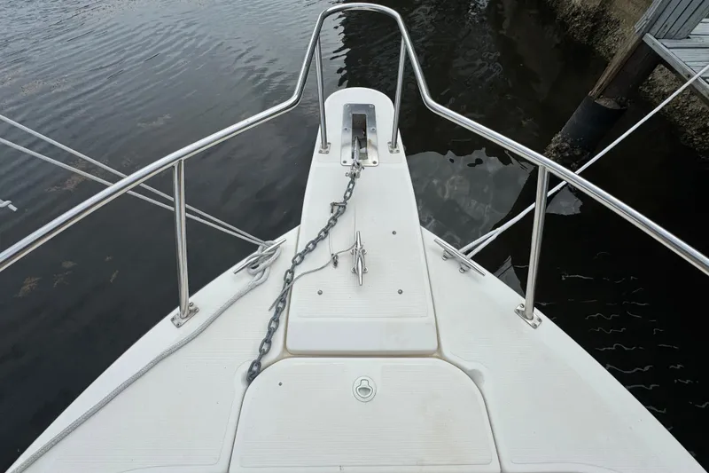 Slide: The Image of Bow of 2000 Pursuit 2470 Walkaround boat with anchor chain and railing. - 3