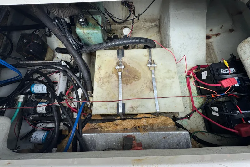 Slide: The Image of Engine compartment of a 2000 Pursuit 2470 Walkaround boat, showing wiring and components. - 31