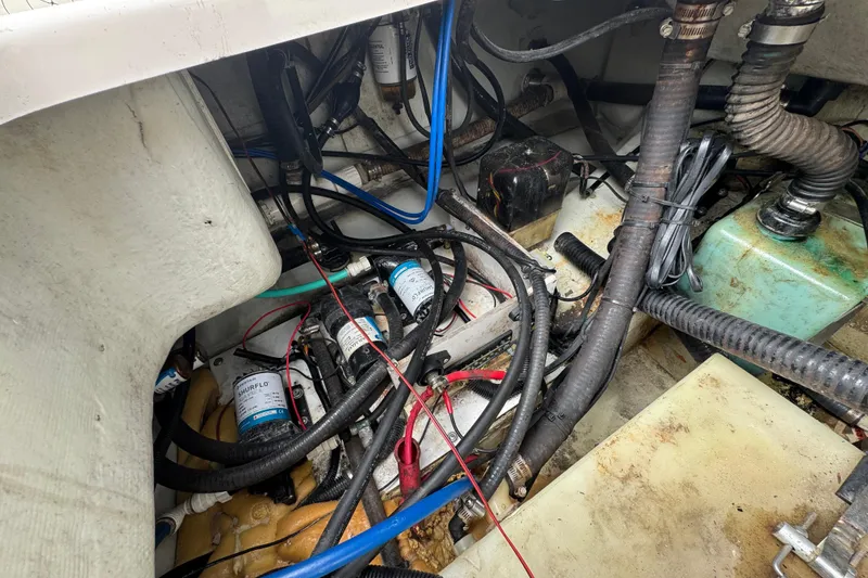 Slide: The Image of Engine compartment of a 2000 Pursuit 2470 Walkaround boat, showing wiring and components. - 32