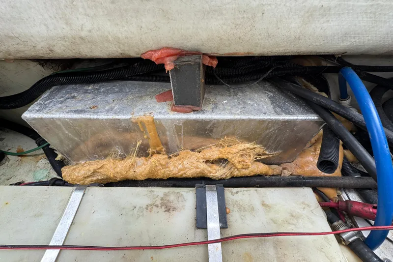 Slide: The Image of Engine compartment of a 2000 Pursuit 2470 Walkaround boat with visible wiring and insulation. - 34