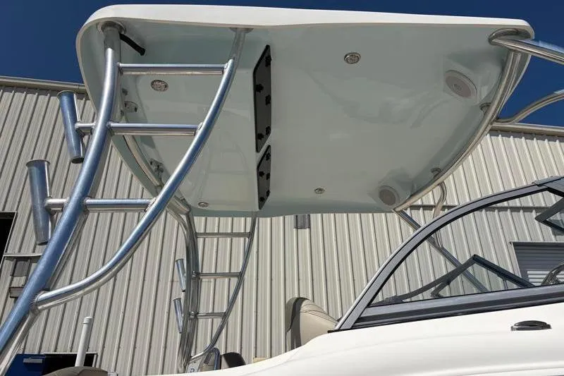 Slide: The Image of 2023 Key West 239 DFS boat with T-top and ladder, against a clear blue sky. - 13