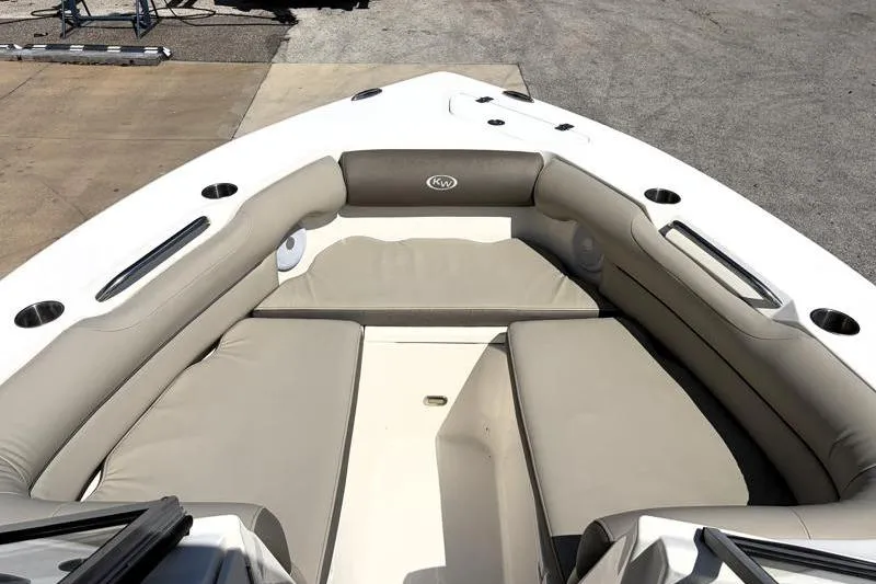 Slide: The Image of 2023 Key West 239 DFS boat interior with cushioned seating and cup holders. - 15