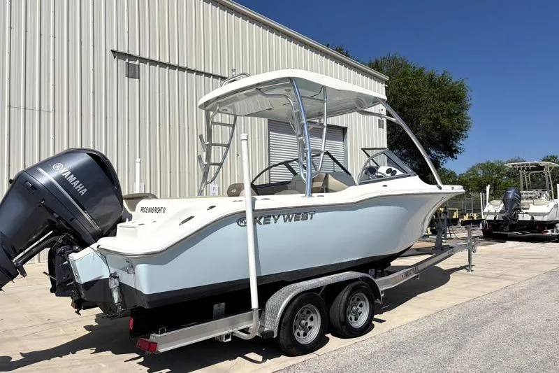 Slide: The Image of 2023 Key West 239 DFS boat on trailer, featuring Yamaha outboard motor. - 2