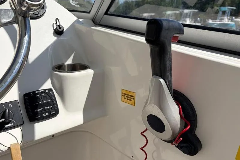 Slide: The Image of 2023 Key West 239 DFS boat cockpit with steering wheel and throttle controls. - 22