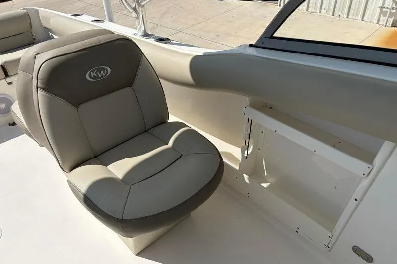 Slide: The Image of 2023 Key West 239 DFS boat interior with cushioned seating and storage compartment. - 26