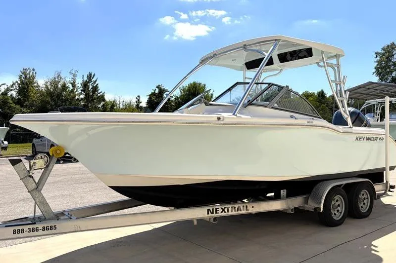 Slide: The Image of 2023 Key West 239 DFS boat on trailer under clear blue sky. - 3