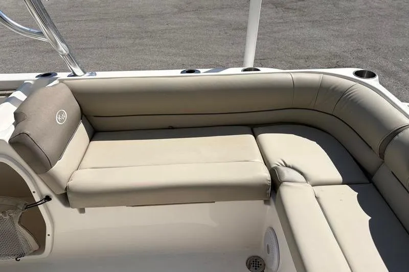 Slide: The Image of 2023 Key West 239 DFS boat interior with beige cushioned seating. - 30