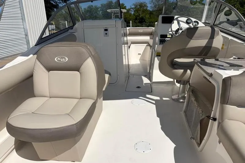 Slide: The Image of Interior of 2023 Key West 239 DFS boat with beige seating and steering console. - 31