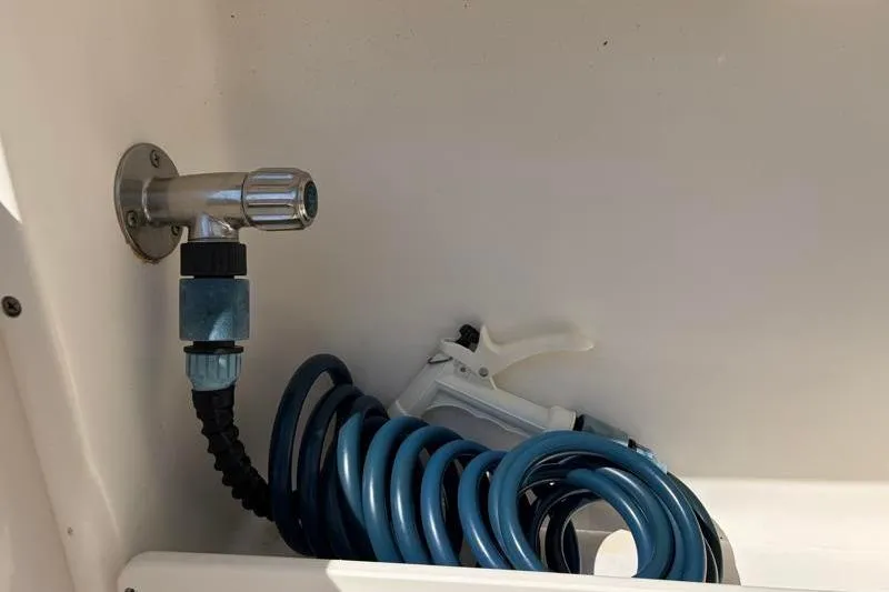 Slide: The Image of Coiled blue hose and nozzle on 2023 Key West 239 DFS boat. - 32