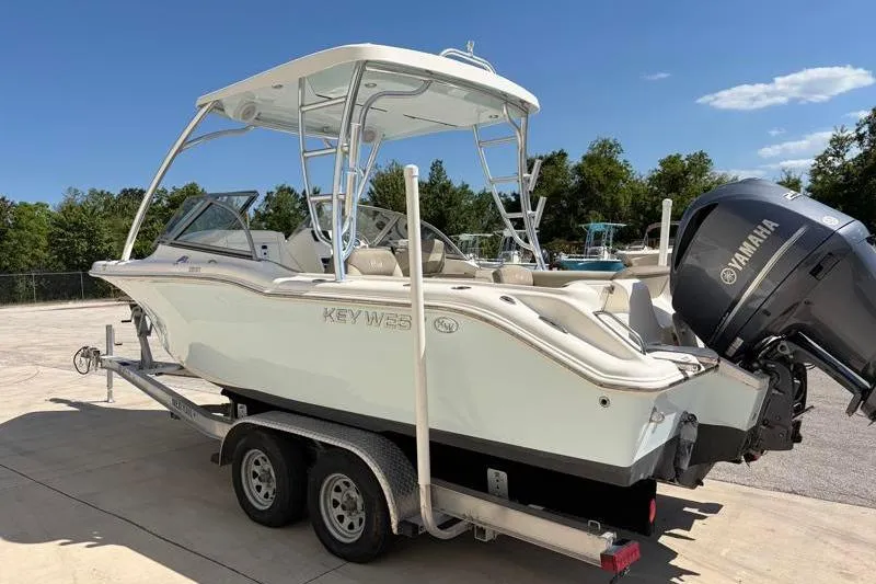 Slide: The Image of 2023 Key West 239 DFS boat on trailer with Yamaha engine, parked outdoors. - 5